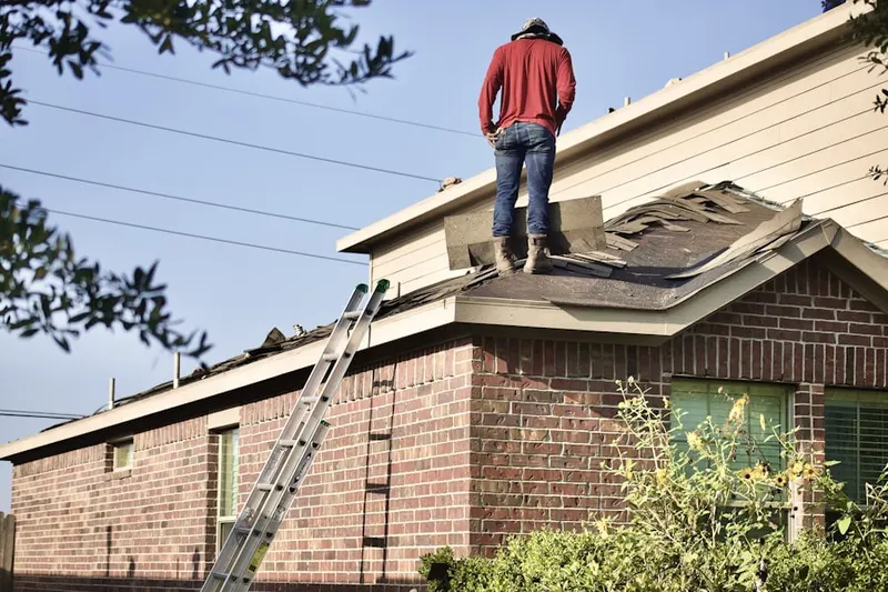 Professional roofer working on a residential roof in Lotus Woods